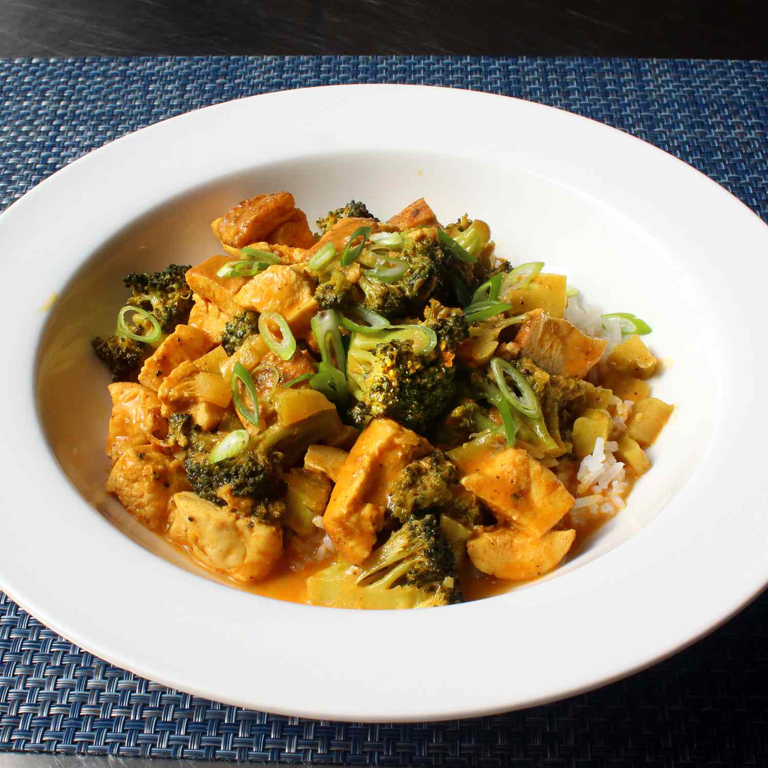 close up view of Chicken and Broccoli Curry in a white bowl