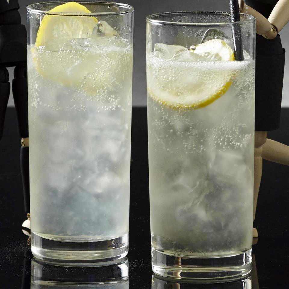 close up view of two French 75 cocktails garnished with lemon in glasses