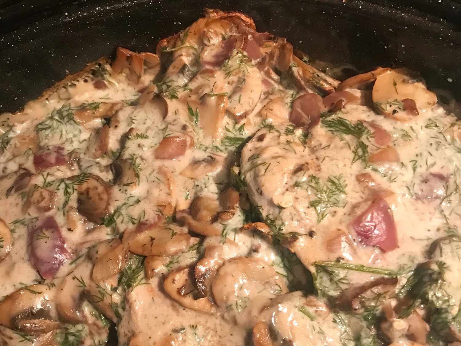 close up view of Pork Chop Casserole with herbs in a baking dish