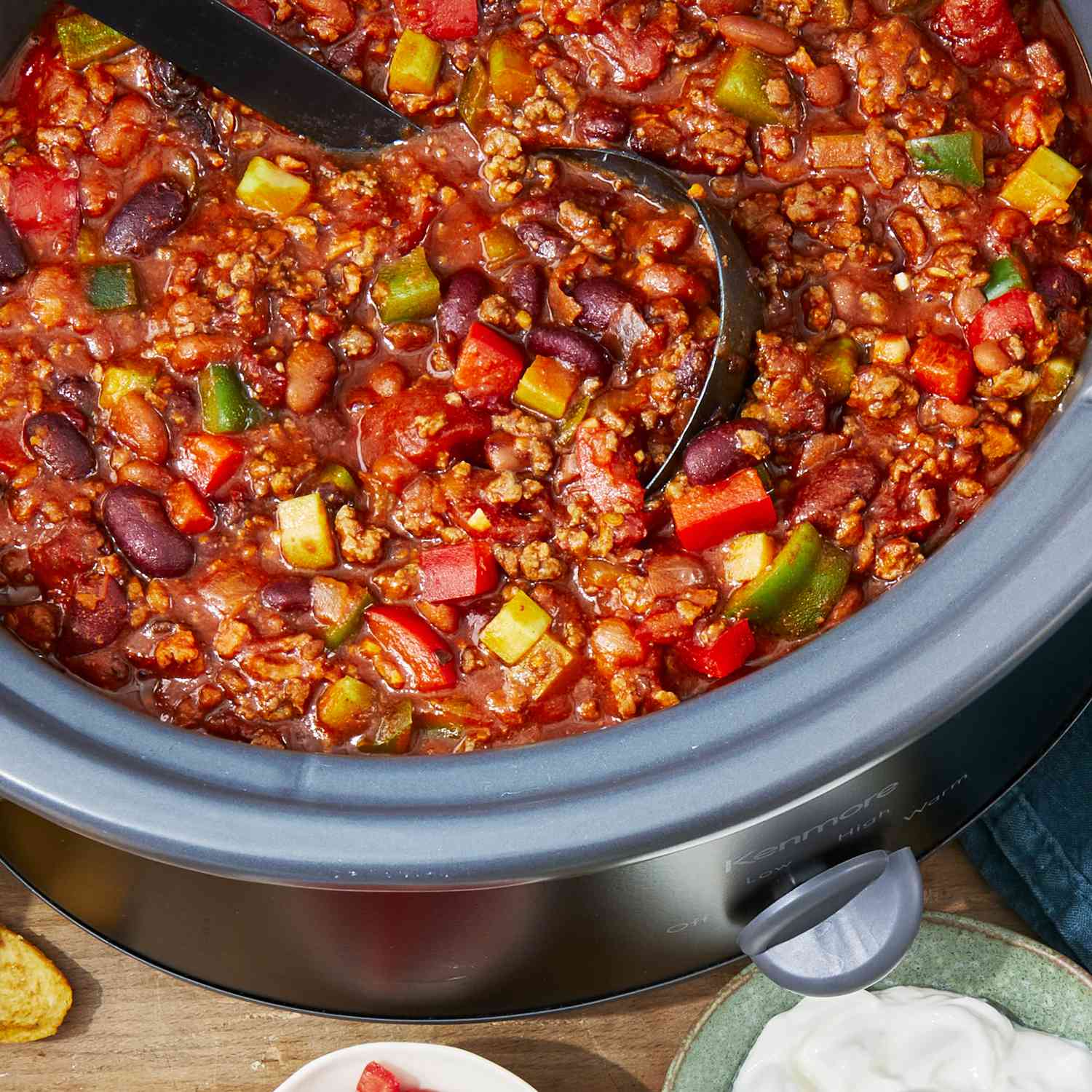 a close up top down view of chili in a light blue slow cooker