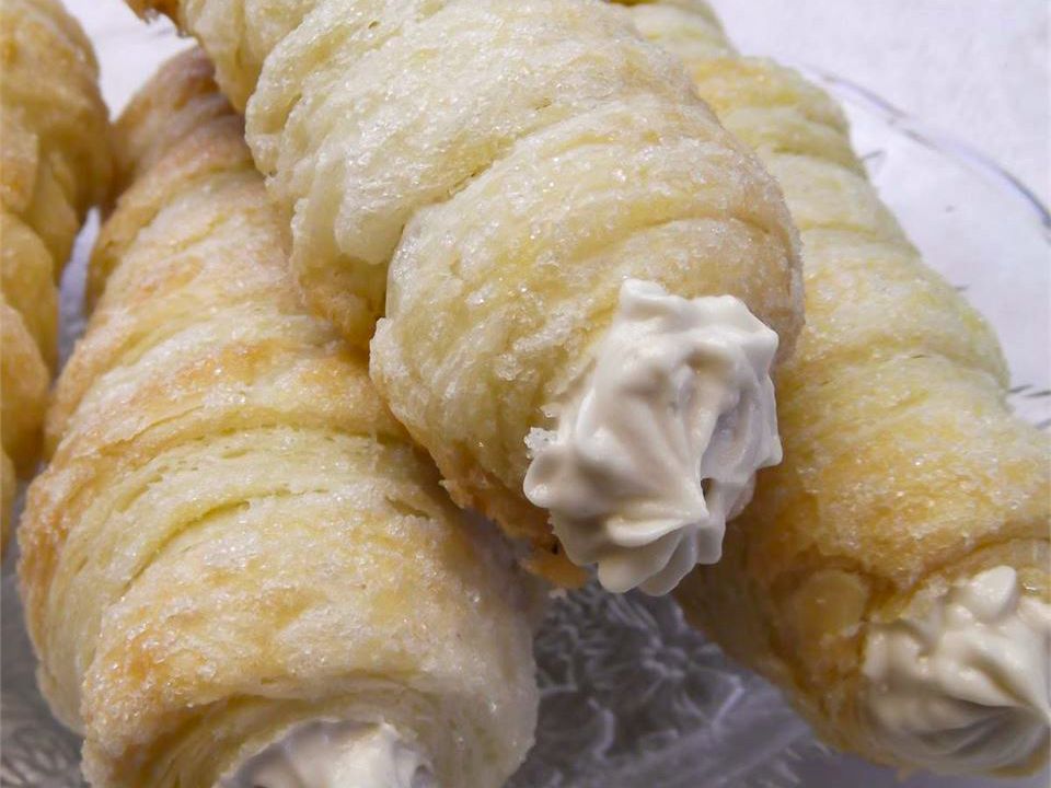 close up view of Homemade Cream Horns on a white platter