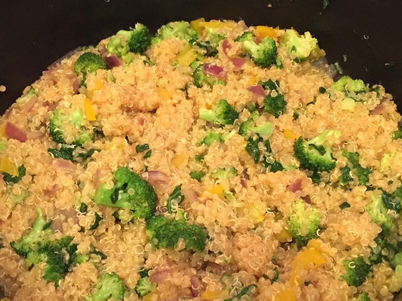 close up view of Veggie Quinoa with broccoli, peppers and red onions in a pan