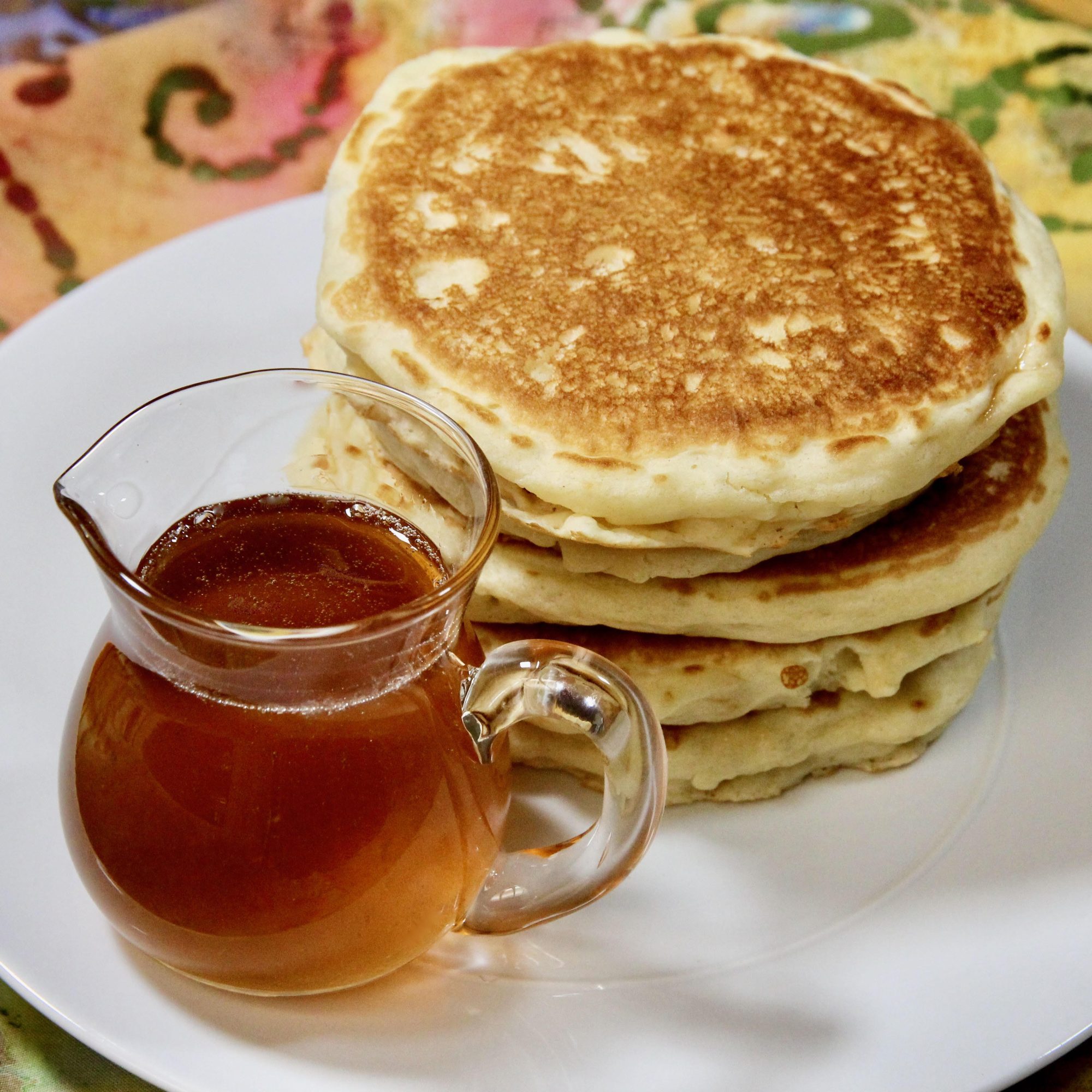 syrup in jar with pancakes