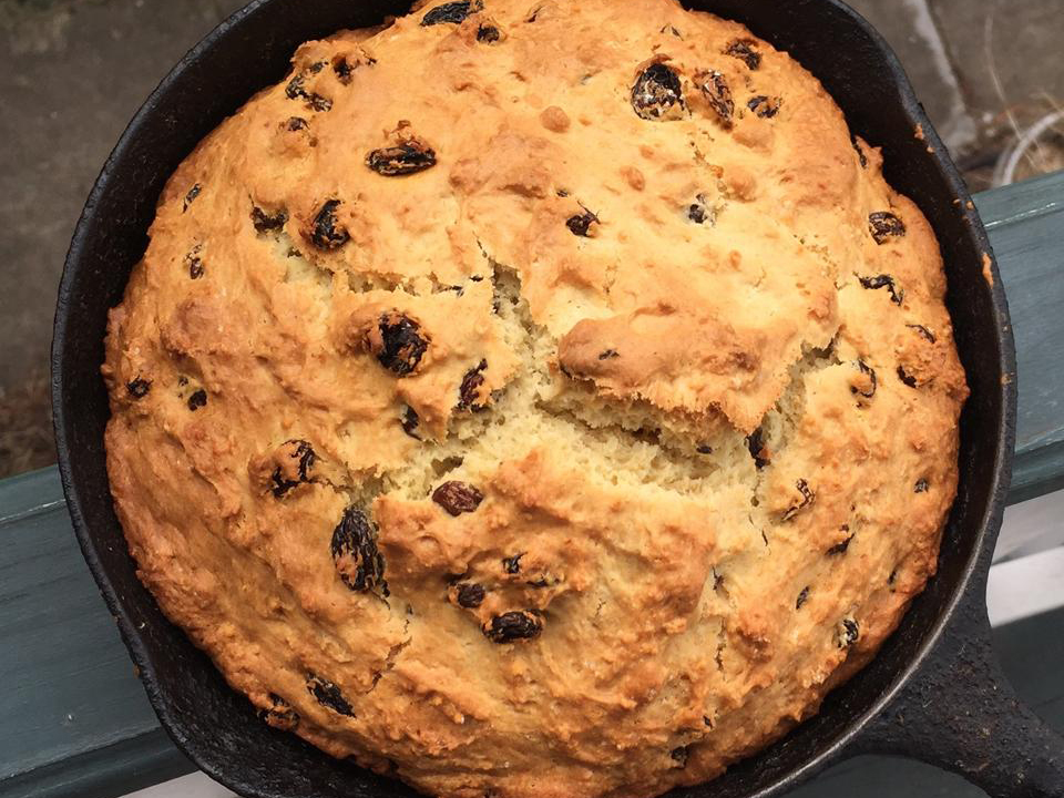 close up view of an Irish Soda Bread in a cast iron skillet