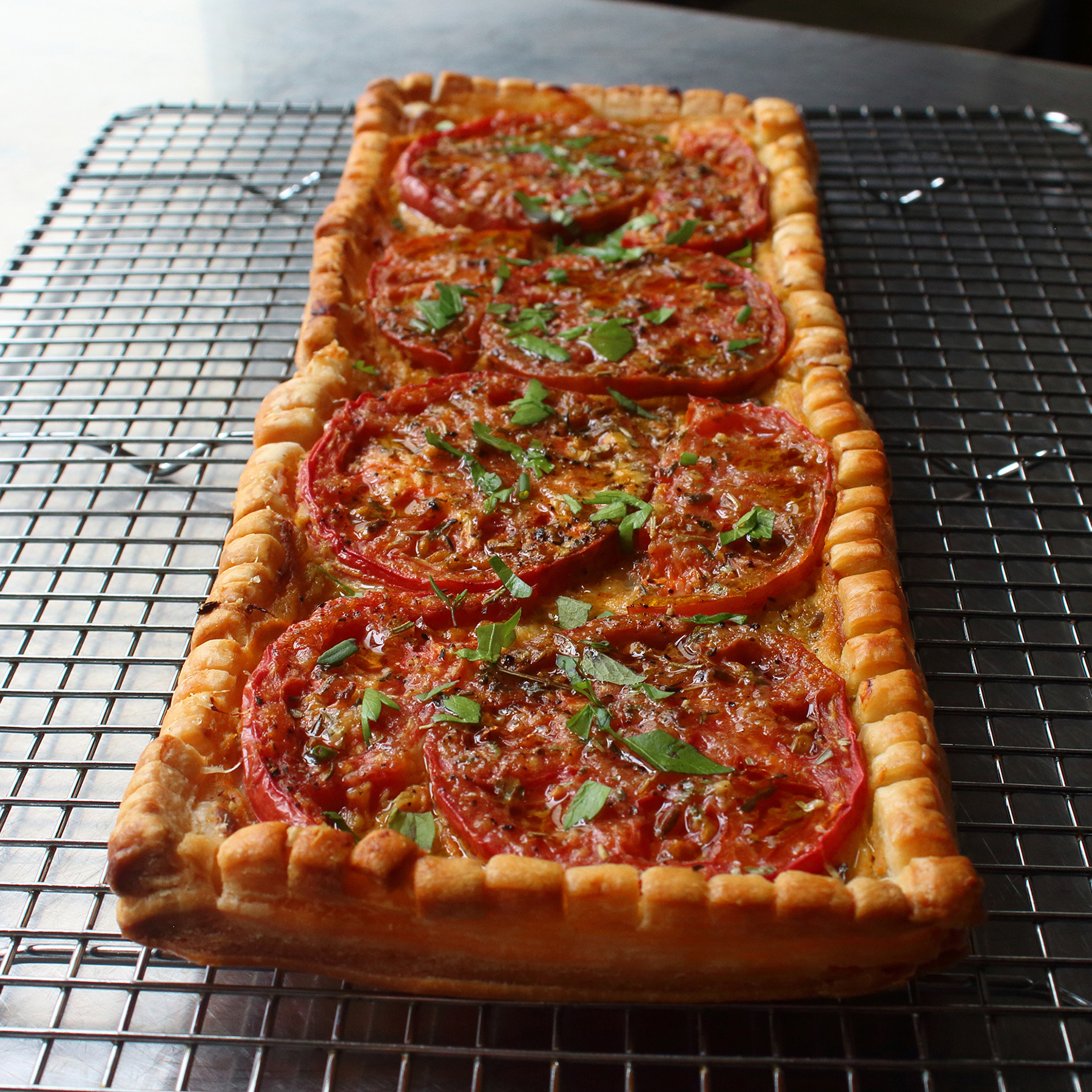 close up view of a Tomato Tart on a cooling rack
