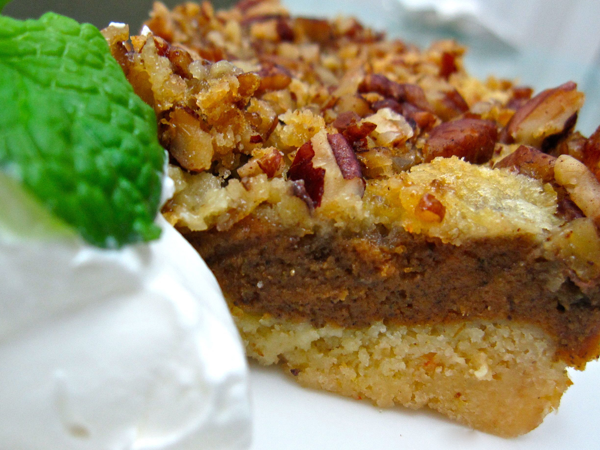 close up of a slice of Pumpkin Crumb Cake served with cream and mint on a plate