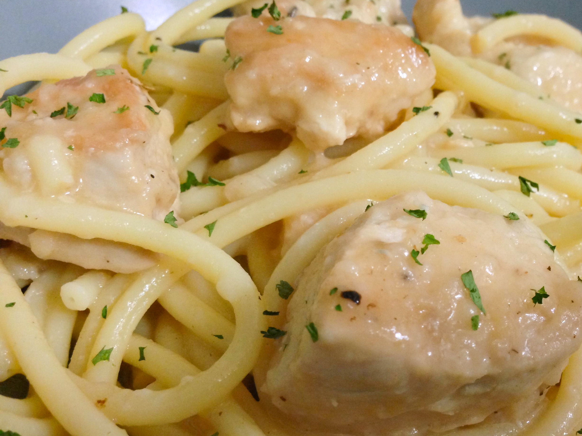 close up view of Garlic Wine Chicken with pasta in a bowl