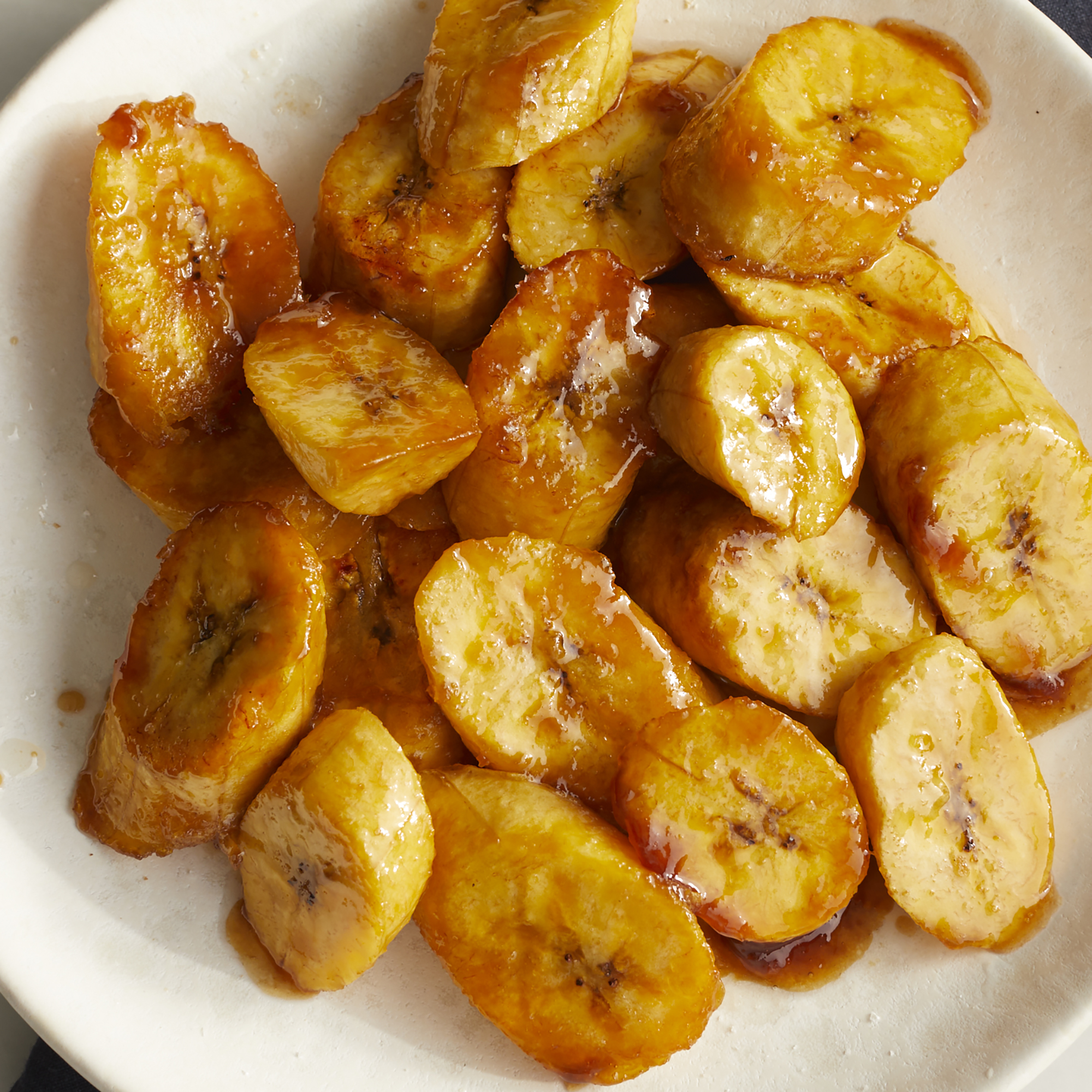 looking down at a bowl of sliced, sautéed sweet plantains