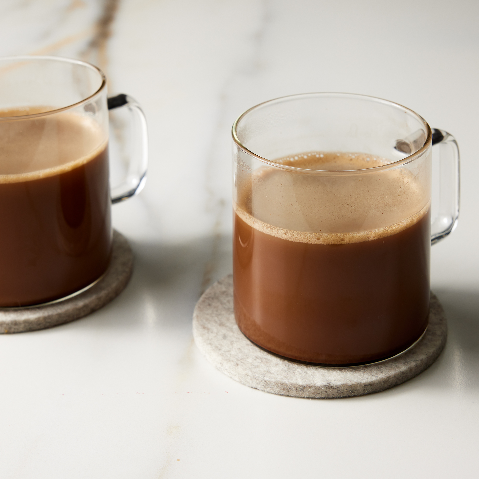 close up on two glass mugs of mocha coffee