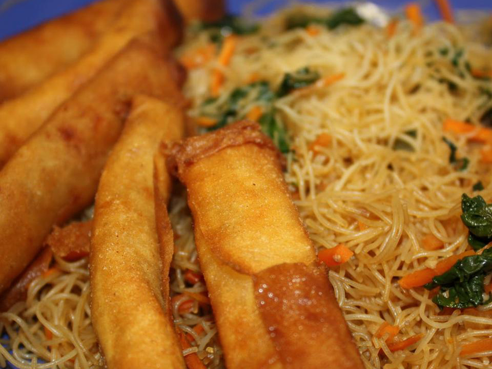 close up view of Lumpia and Pancit and spring rolls on a plate