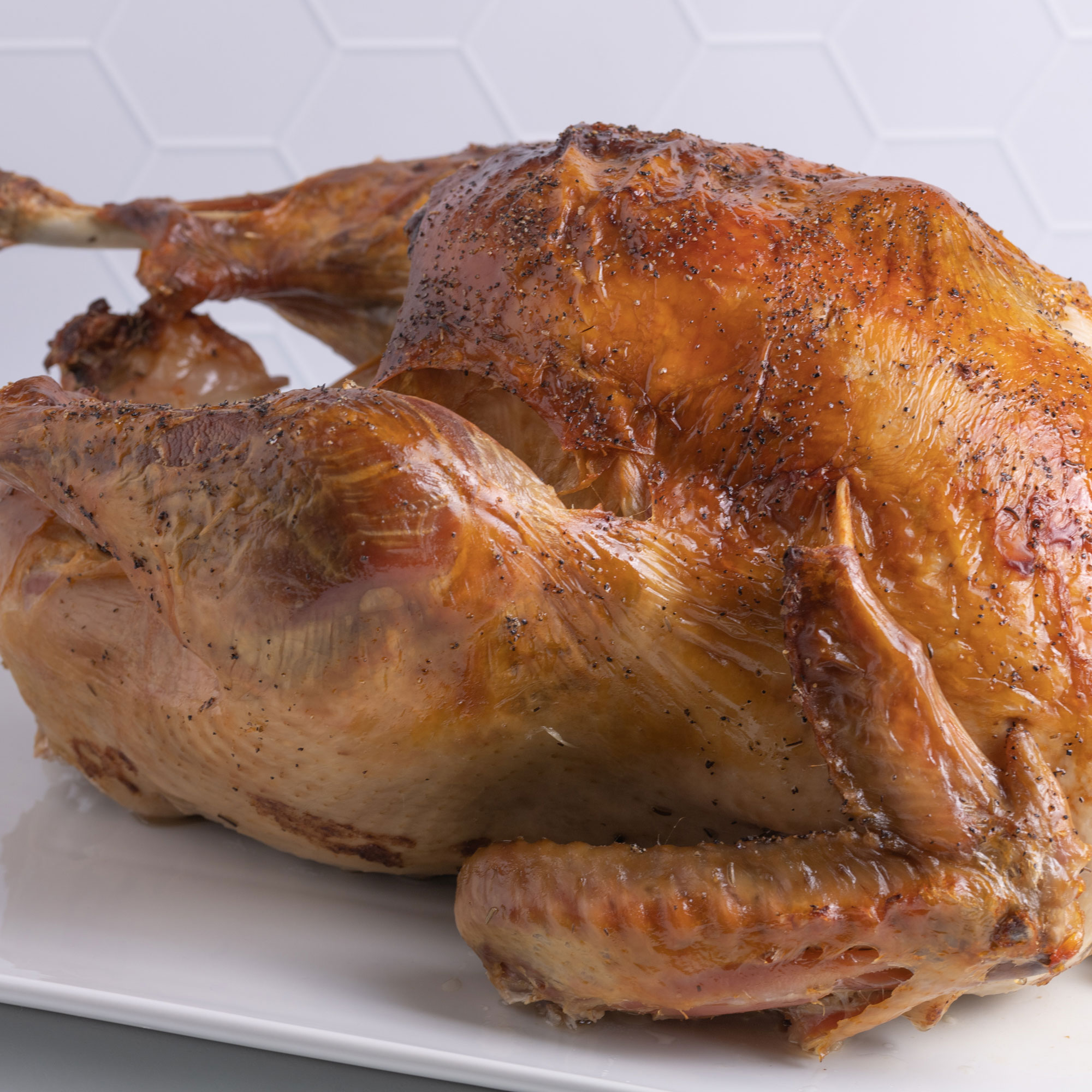 a close up view of a perfectly golden-brown whole turkey