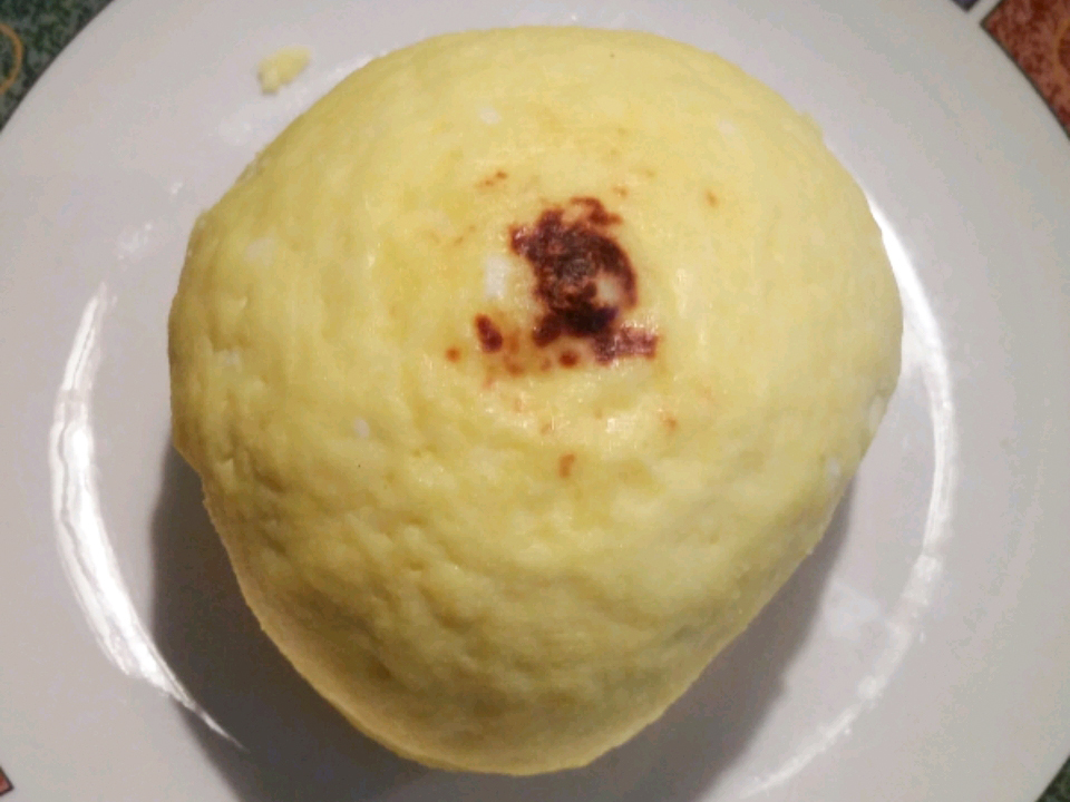 close up view of a ball of Sirecz (Easter Cheese) on a white plate