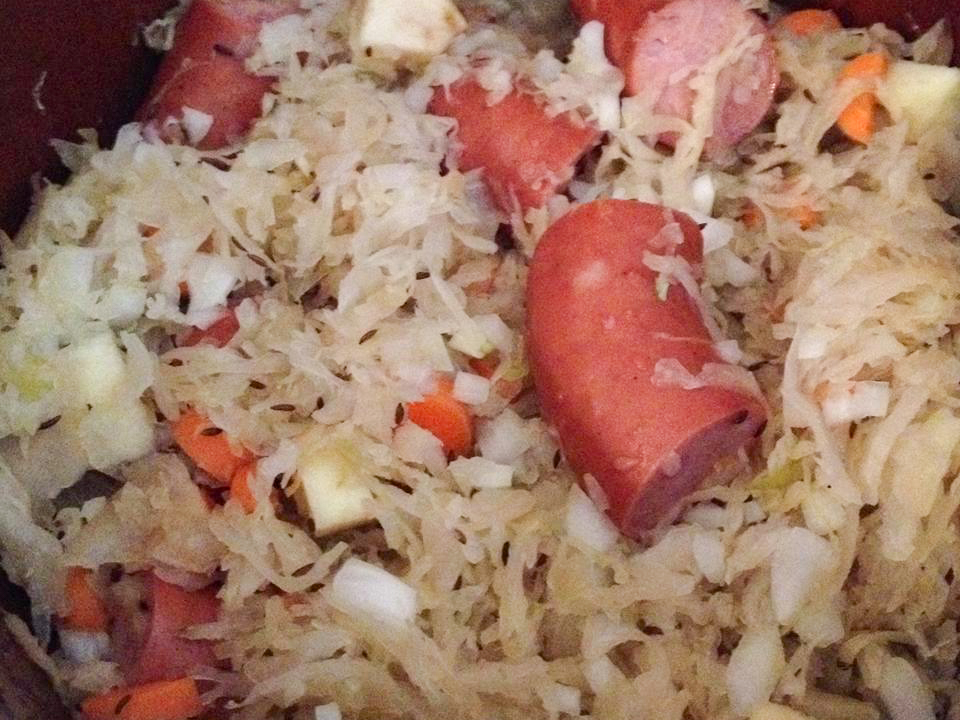 close up view of Sweet Slow Cooker Sauerkraut with sausage in a pot