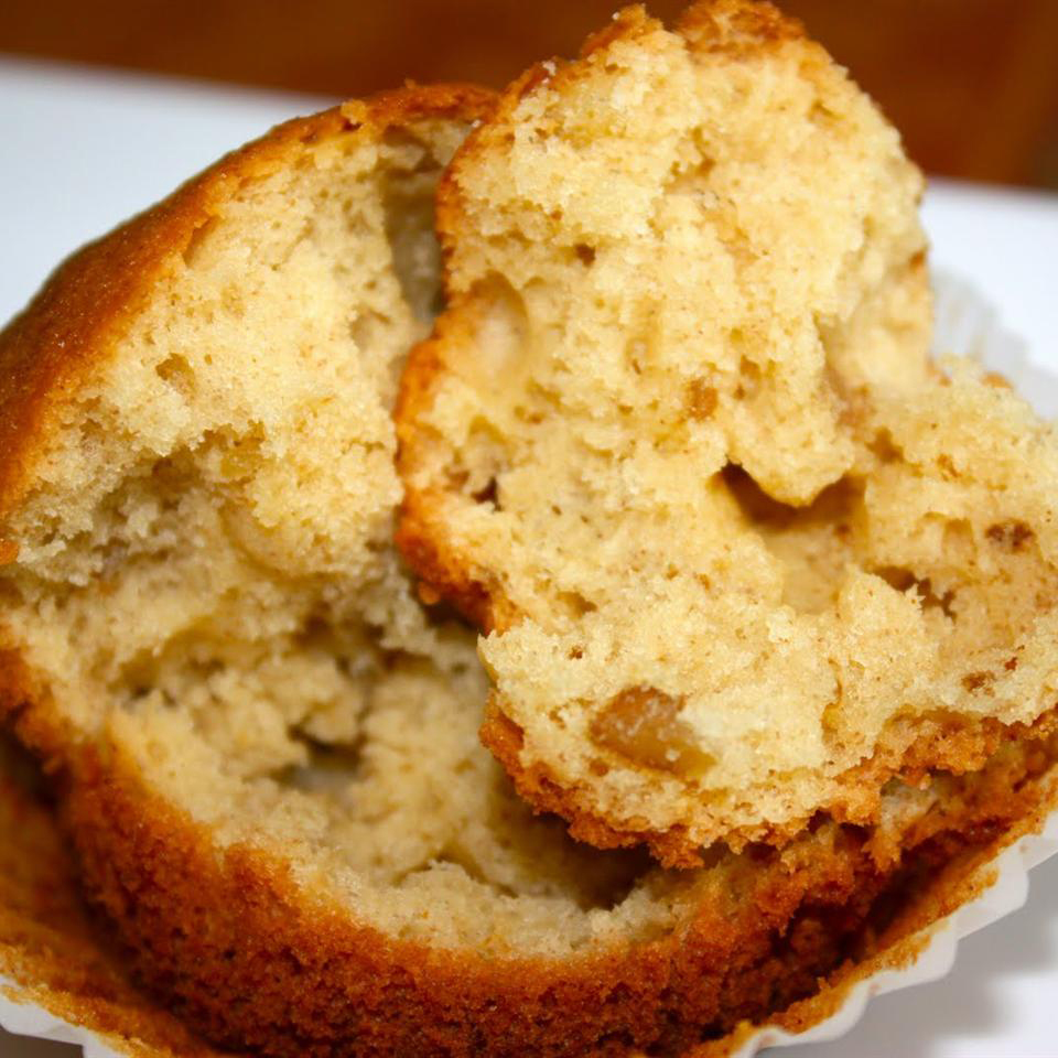 close up view of a Gluten Free Banana Bread muffin on a muffin liner