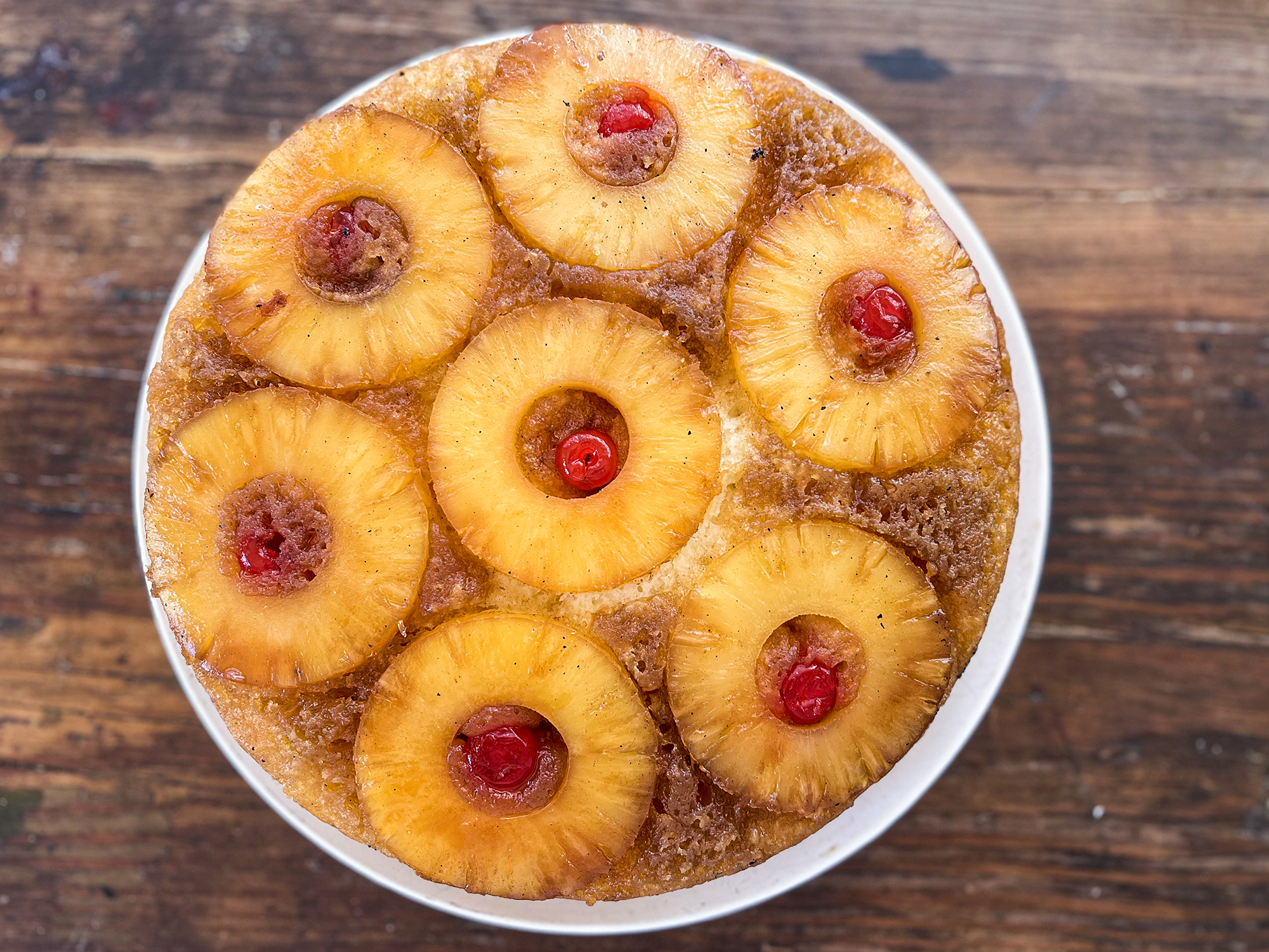 a top down view of a perfectly baked upside down pineapple cake