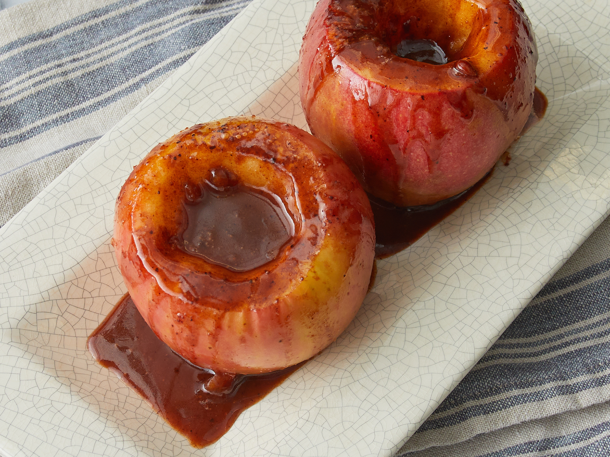 looking at two microwave baked apples on a plate