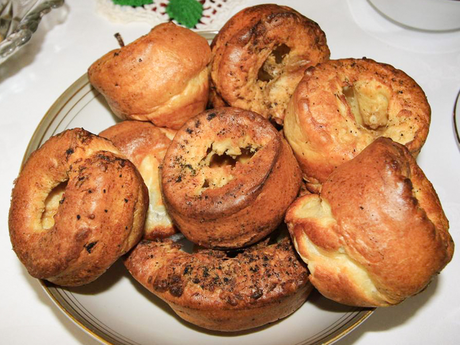 close up view of a pile of Yorkshire Puddings on a plate