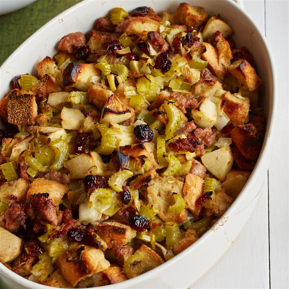close up view of Cranberry, Sausage and Apple Stuffing in a white baking dish