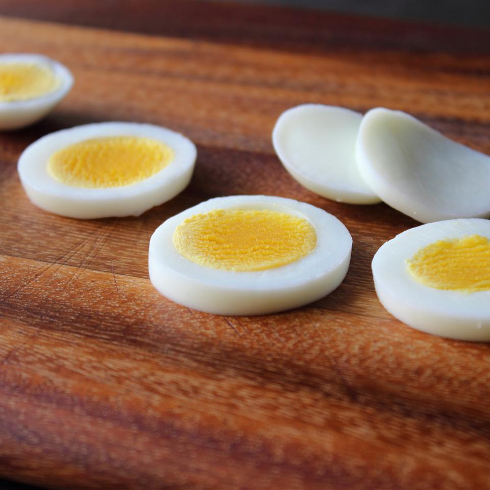 close up view of sliced Soft Hard-Boiled Eggs on a wooden board