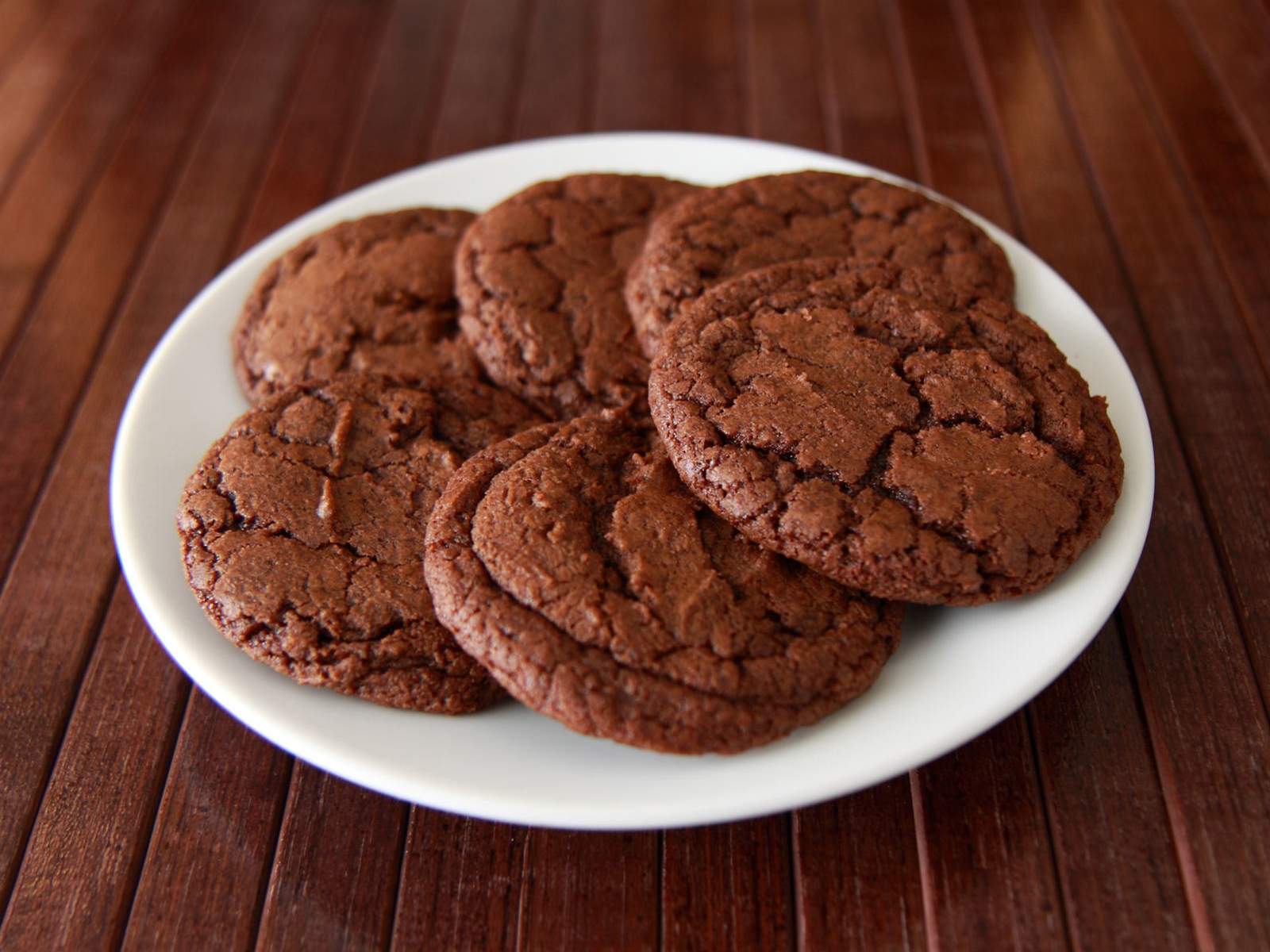 close up view of a pile of Double Chocolate Cookies on a white plate