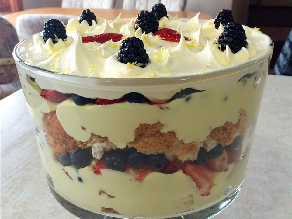 close up view of a Lemon Berry Trifle garnished with berries and lemon zest in a trifle pan