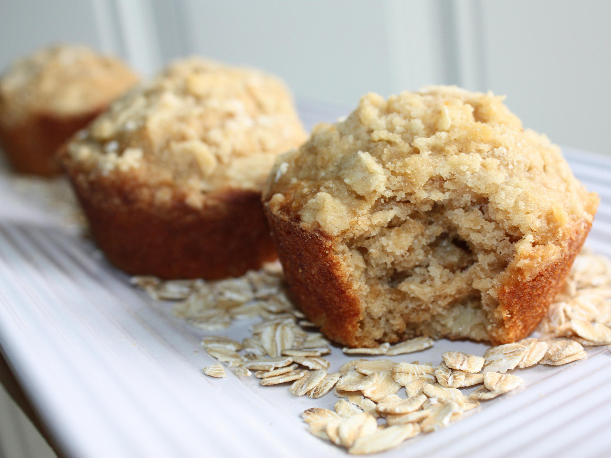 close up view of Peanut Butter Banana Muffins with oatmeal on a white platter