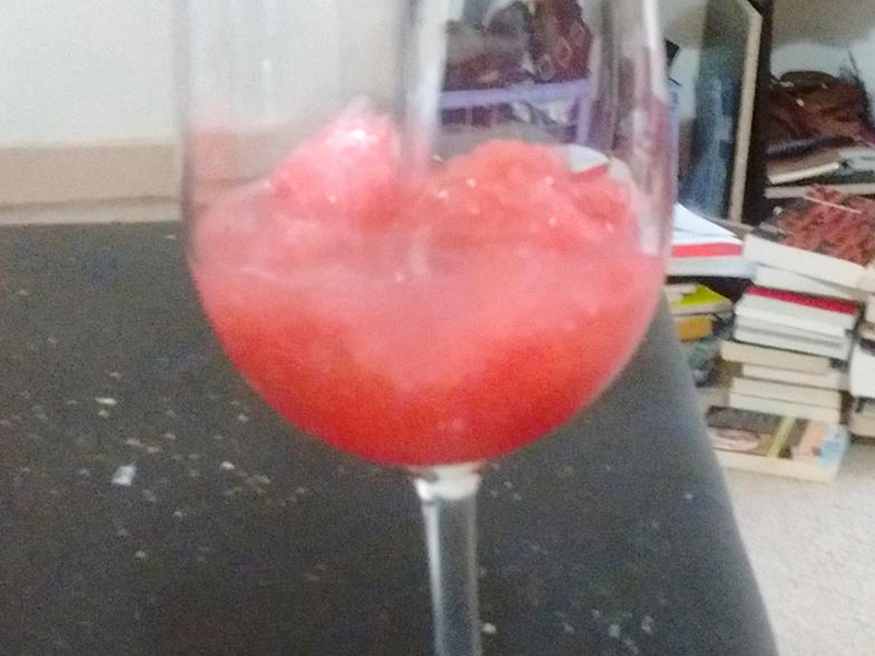 close up view of a pink Rhubarb Slush in a wine glass
