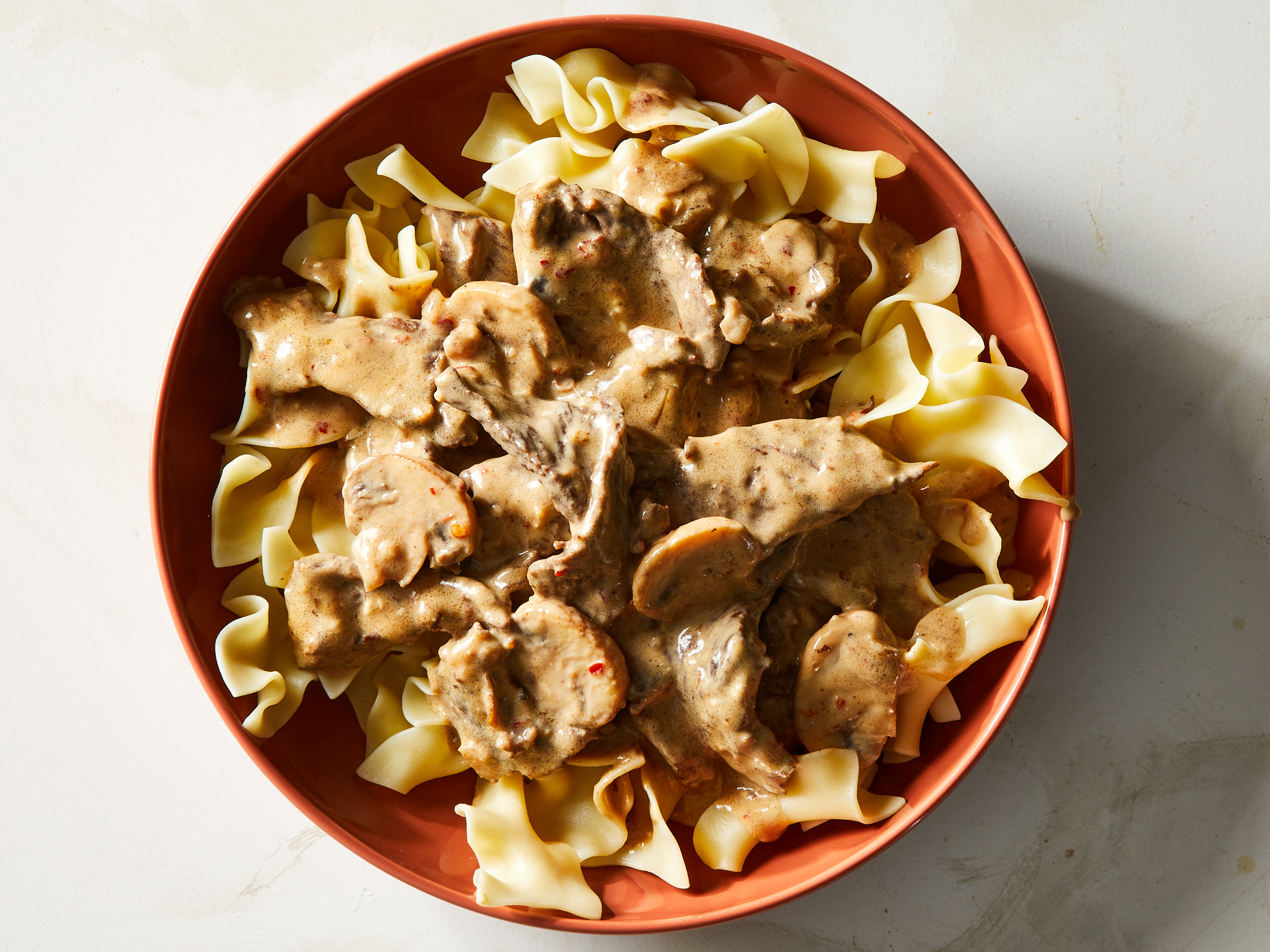 looking down at a large bowl of rich and creamy beef stroganoff