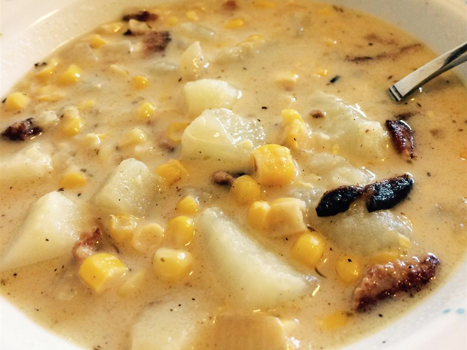 close up view of Cheesy Corn Chowder with potatoes in a bowl