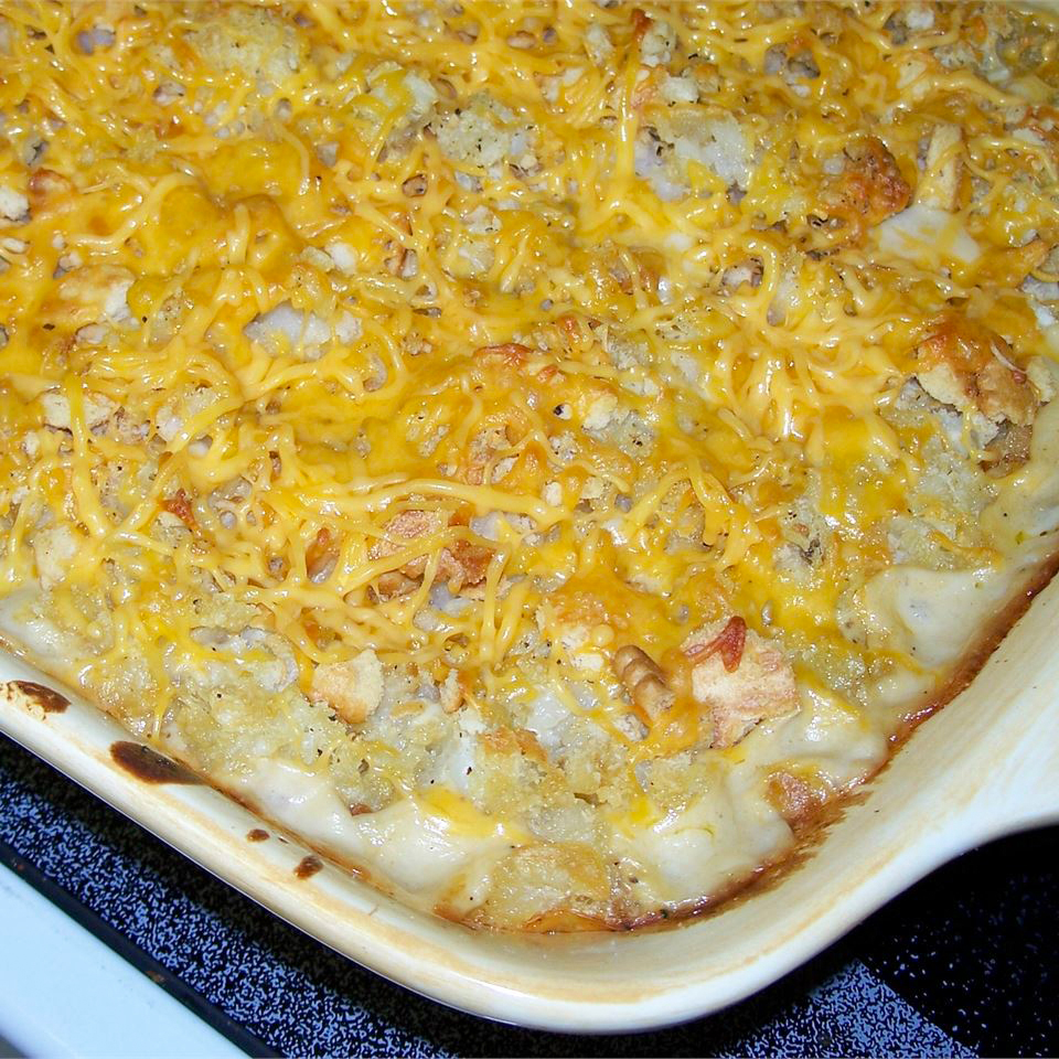 close up view of Creamy Tater Tot Casserole with melted cheese on top, in a baking dish