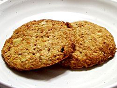 close up view of two Digestive Biscuits on a white plate