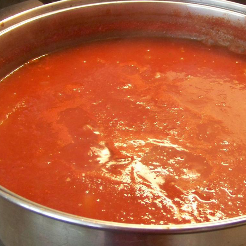 close up view of Tomato Harvest Marinara Sauce in a metal pot