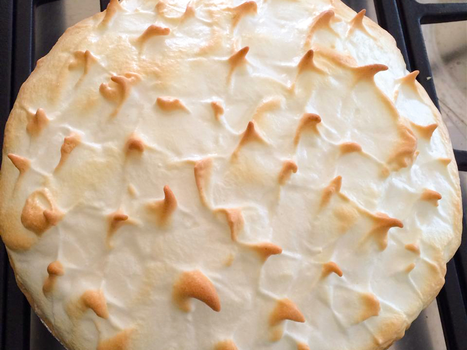 close up view of an Old Fashioned Lemon Pie with a toasted meringue topping, on a stove top