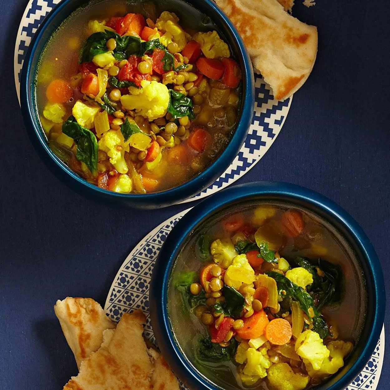 Slow-Cooker Moroccan Lentil Soup in bowls with flat bread