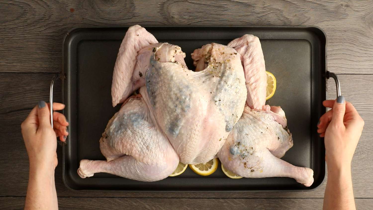 Roasting spatchcock turkey on a bed of lemons