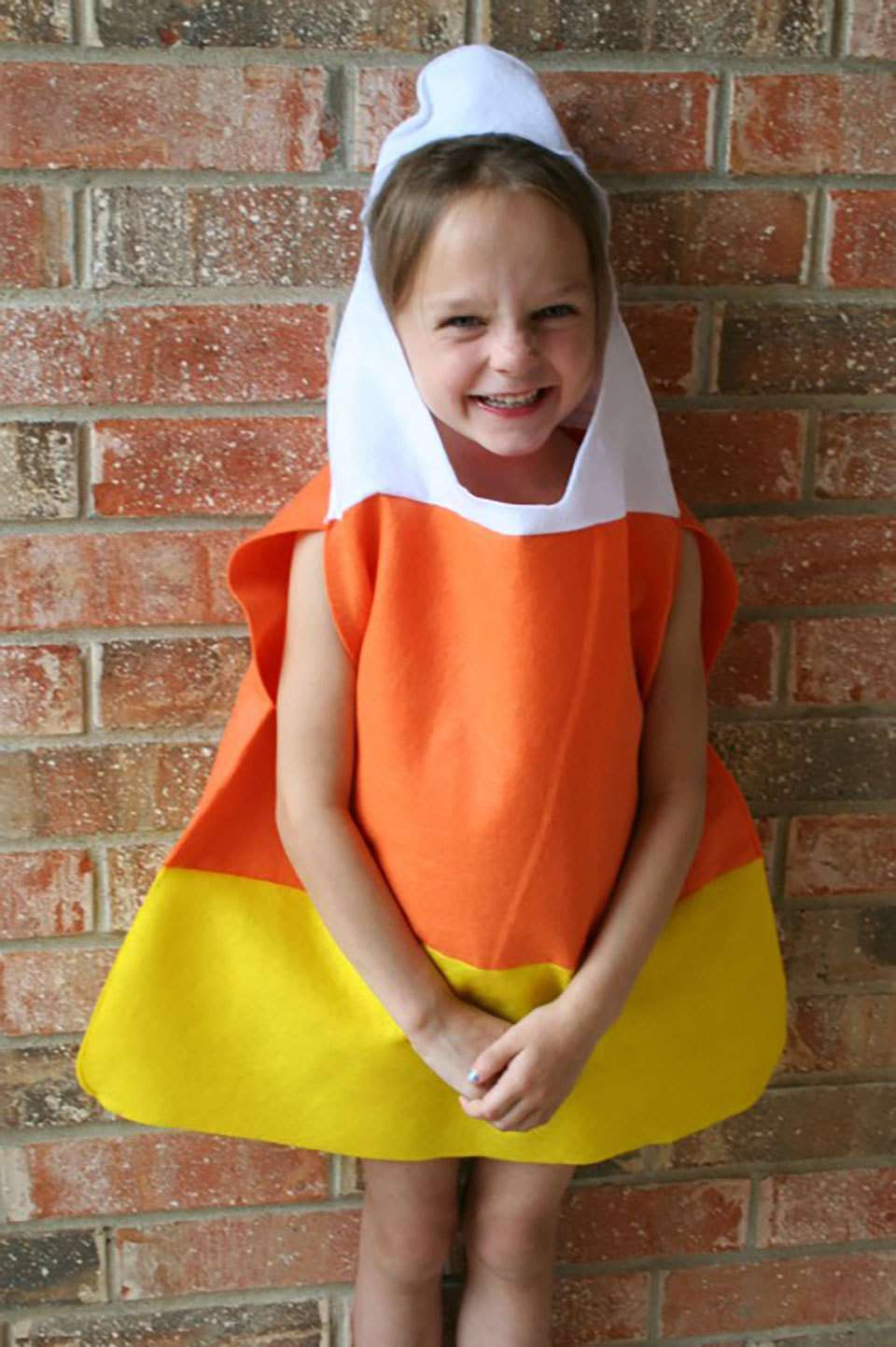 child wearing a candy corn costume