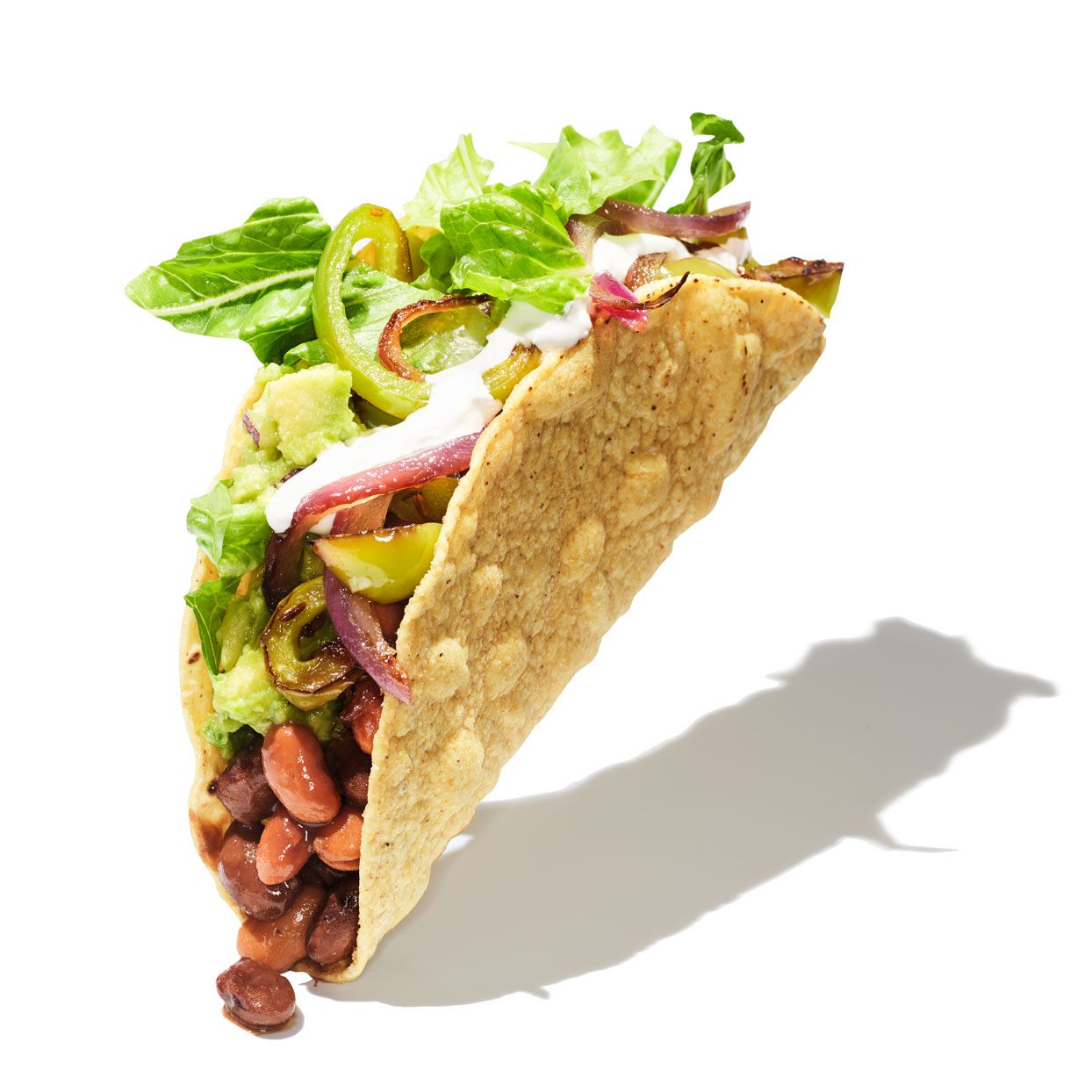 chipotle taco on white background with beans and vegetables