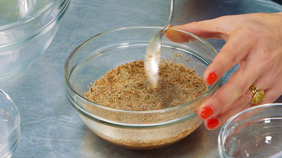 mixing flax and egg in a bowl with a spoon