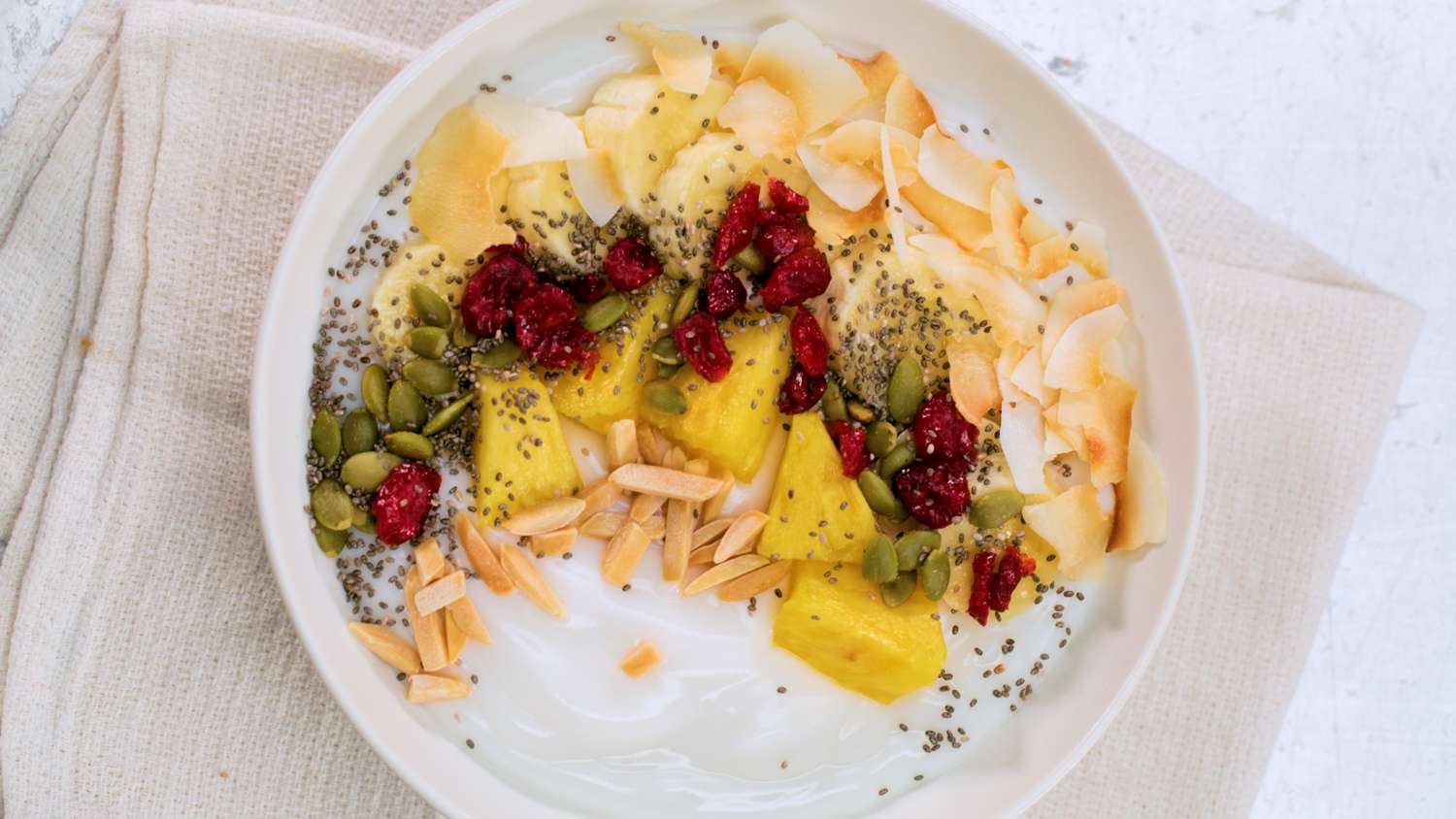 yogurt bowl with fruit and seeds from above