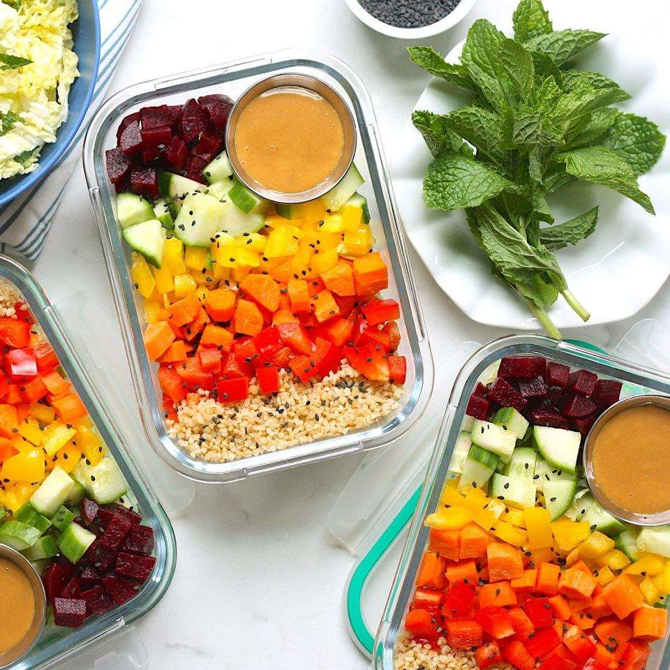 containers of chopped rainbow salad with peanut sauce