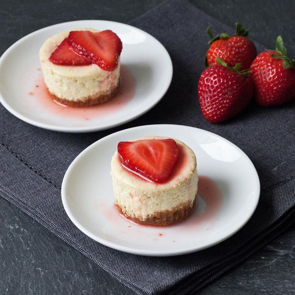 Strawberry-topped cheesecakes on two plates