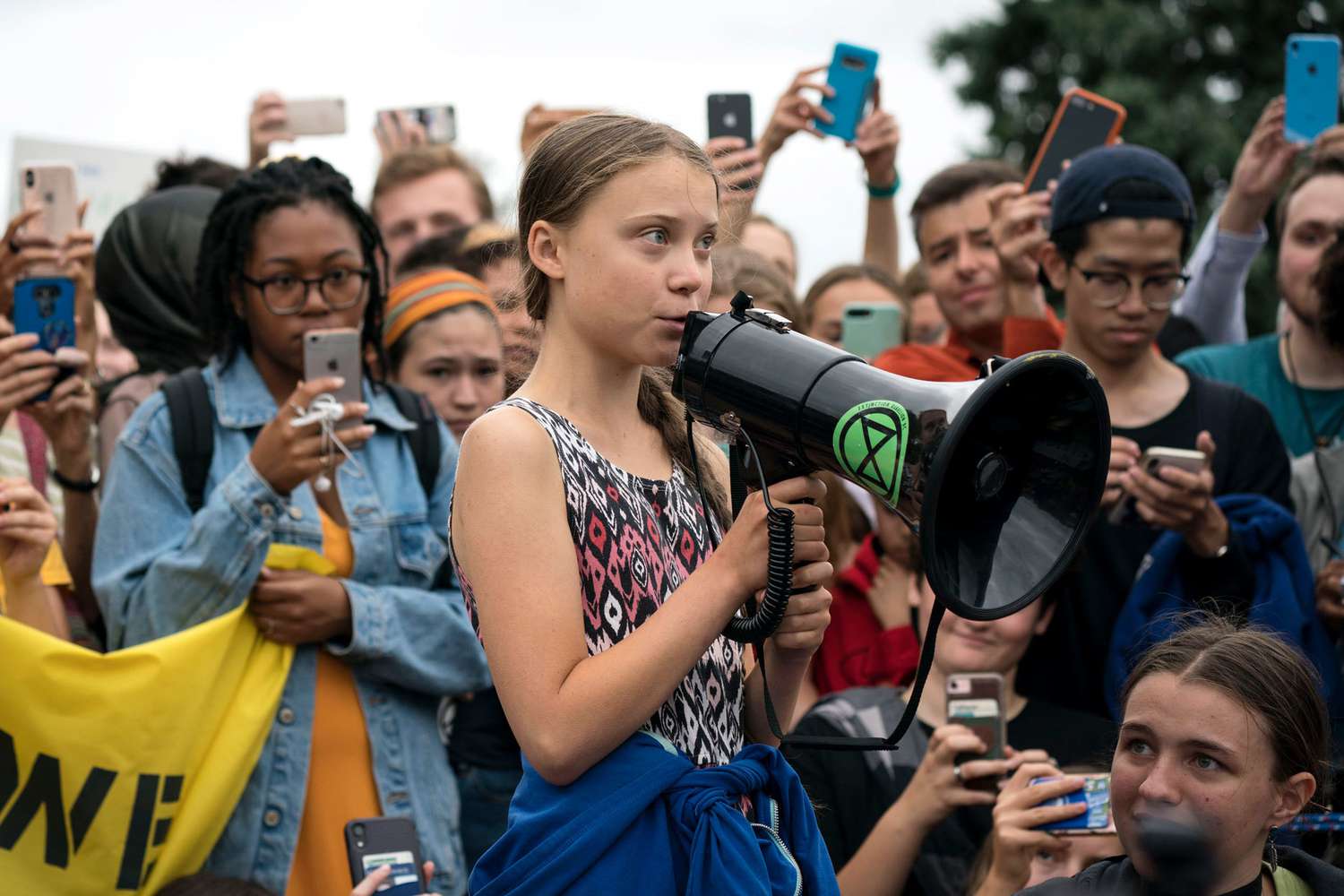 Greta Thunberg in a crowd with a megaphone
