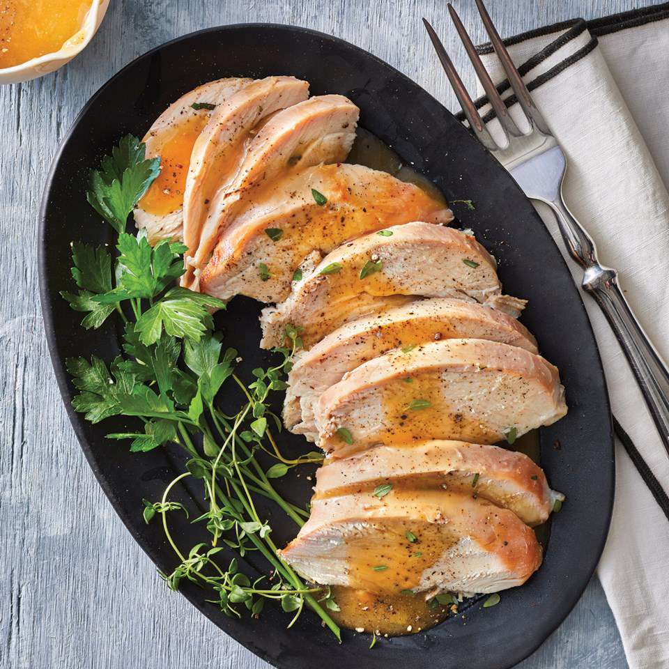 Slow-Cooker Maple Mustard Turkey Breast - sliced and plated with herb garnish