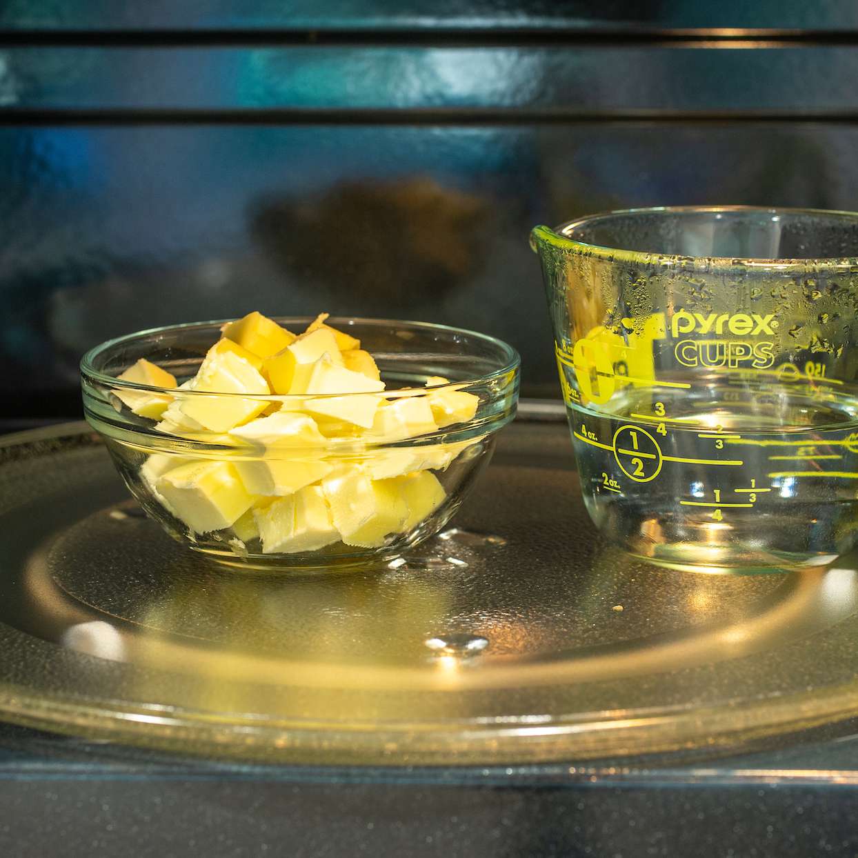 soften bowl of cut up butter with a measuring cup of water in the microwave