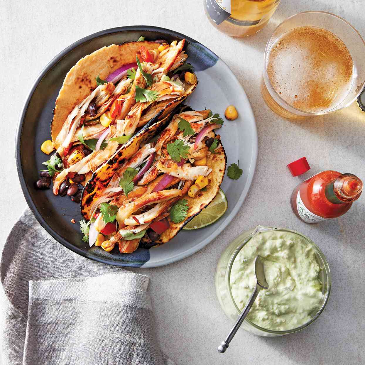<p>A rich, creamy topping made of mashed avocado, sour cream, lime juice and salt takes these spicy slow-cooker chicken tacos to the next level. Lightly toast the tortillas, if desired. Use any leftover avocado cream as a chip dip, and serve with tortilla chips.</p>
                            