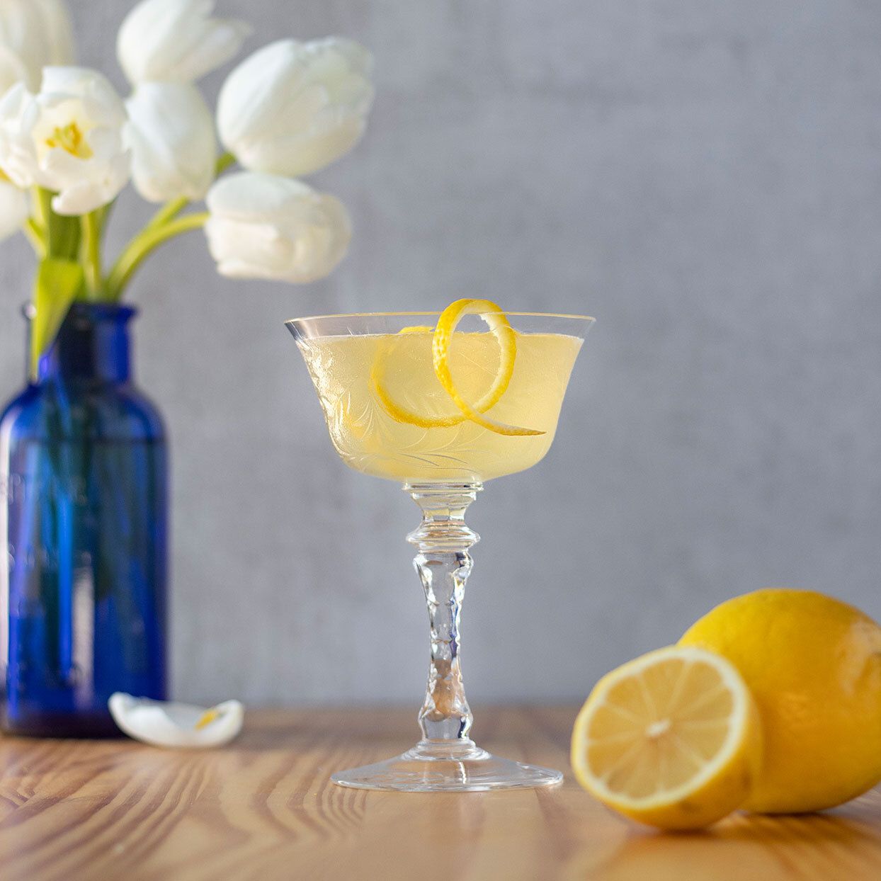 bees knees cocktail with sliced lemon
