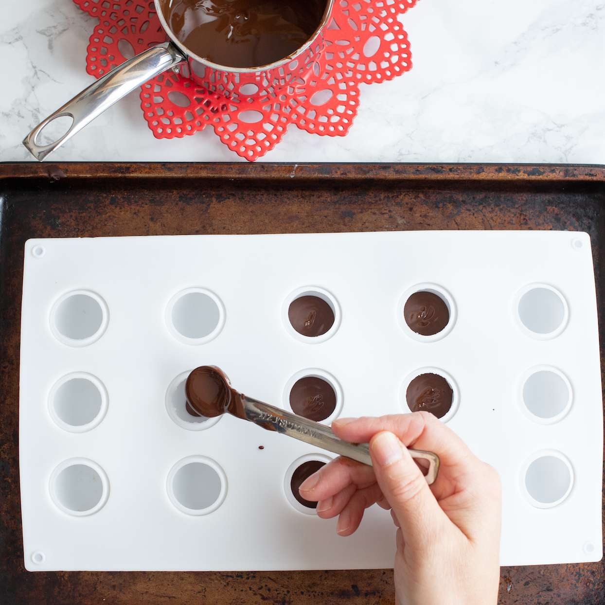 pouring chocolate for hot chocolate bombs
