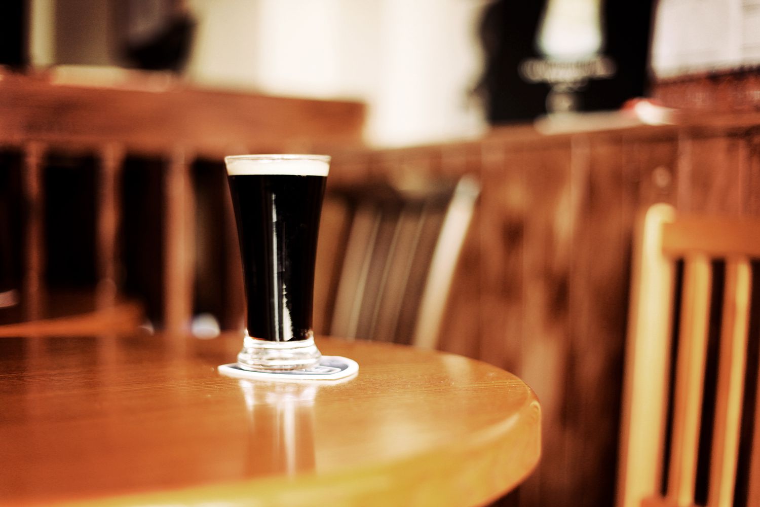 Glass of Guinness on pub table