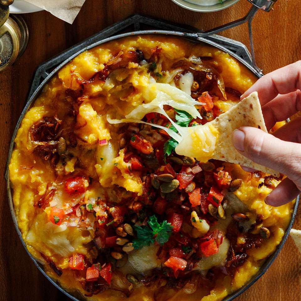a cast iron skillet with a cheesy dip