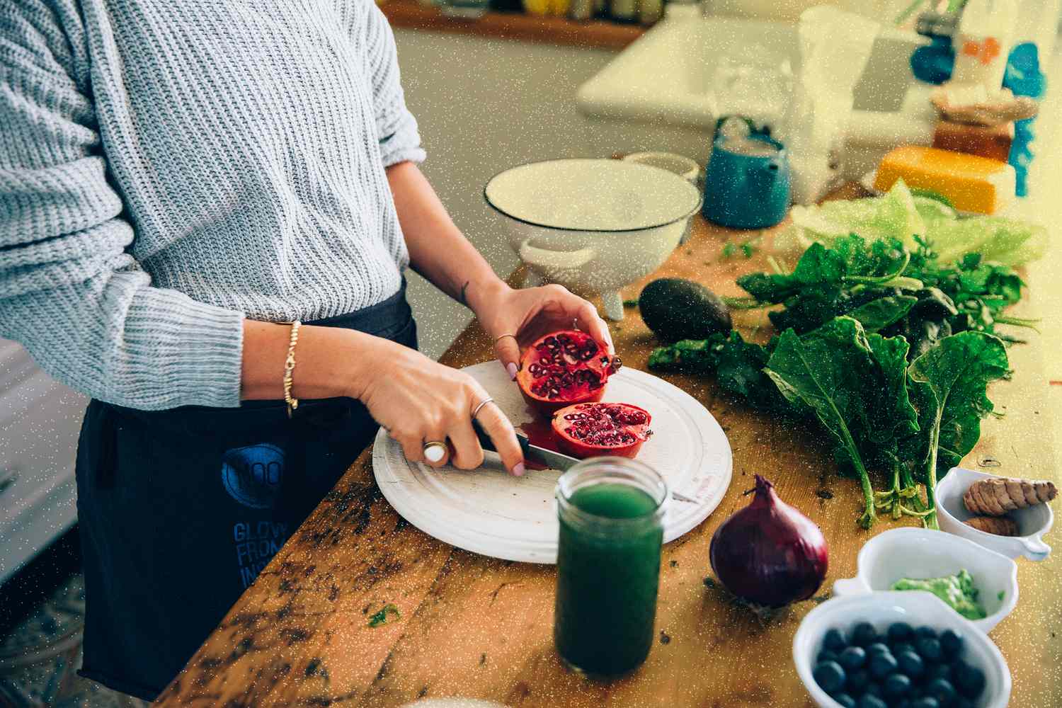 Hands of woman cutting pomegranate